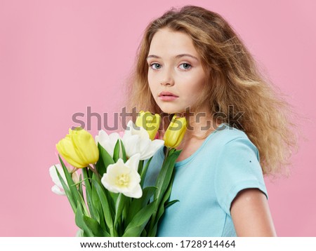 Girl bouquet of flowers blue t-shirt pink background