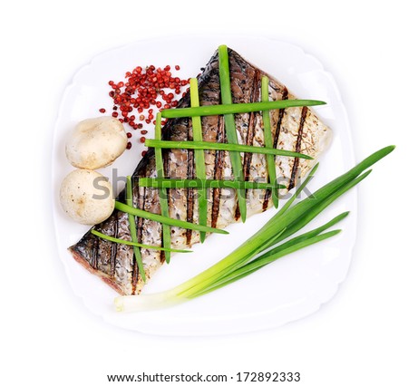 Grilled carp fillet on plate with onion. Isolated on a white background.