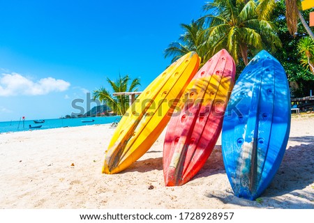 Multi-colored kayaks on a tropical sandy beach. Kayak rental. Tourist entertainment. Royalty-Free Stock Photo #1728928957