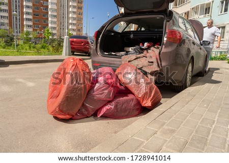 set of wheels. Wheels are packed in bags and lie near the car.
