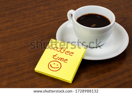 White coffee cup and coffee beans on a wooden table.Coffee time