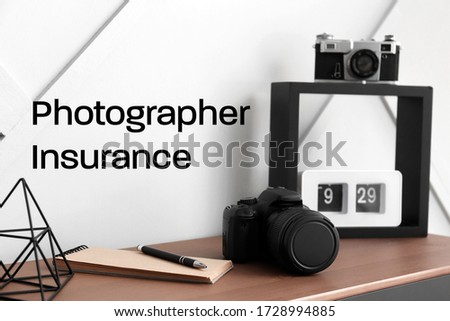 Stylish workplace of modern photographer. Concept of insurance