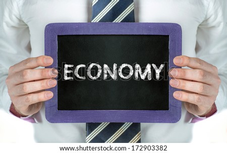 Business man holding board on the background with business word 
