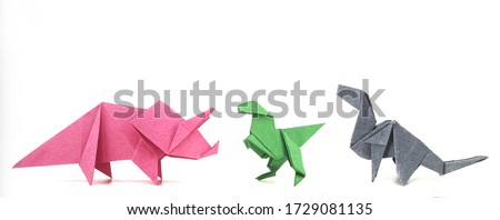Origami, three dinosaurs, on isolated white background, paper crafts.