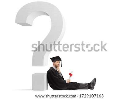 Male graduate student holding a diploma and leaning on a big question mark isolated on white background