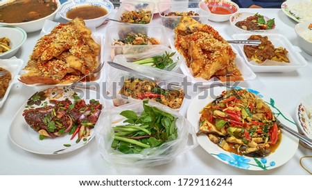 Dishes and boxes of various dishes placed on a white table Royalty-Free Stock Photo #1729116244