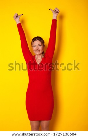 woman forty years in a dress on a yellow background