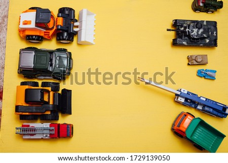 Children's cars toys for developing baby games on a yellow background