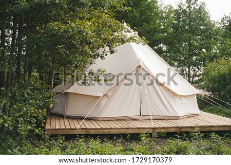 Glamping houses, boho way of living, rural landscape, tent houses Royalty-Free Stock Photo #1729170379