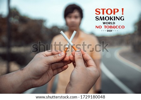 Human hand holding cigarette. Quit smoking for life on World no Tobacco day concept. No smoking concept. Just say NO to STOP Smoking.