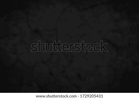 Grunge style. Close-up photo of concrete texture detail, There is a vignette at the corner of the image and a bright spot in the center is a copyspace. The gray and dark cement background old and blur