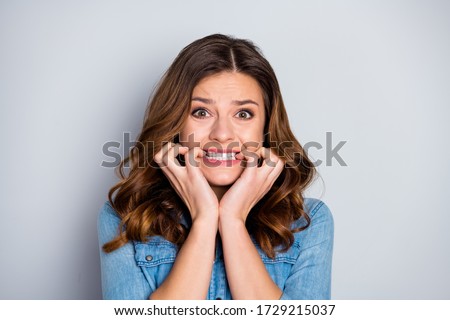 Closeup photo of attractive lady watch news listen bad mood not believe eyes corona virus disease spread infection biting fingers wear casual denim shirt isolated grey color background