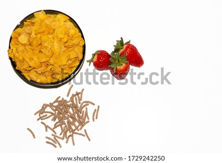 tasty cornflackes, strawberries and bran on a white background