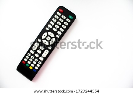 Black TV remote control on a white background 