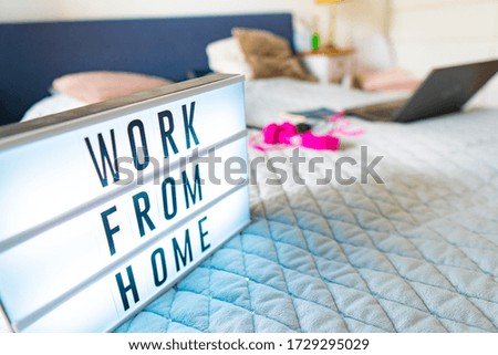 Working from home remote work inspirational social media lightbox message board next to laptop COVID-19 quarantine closure of all businesses.
