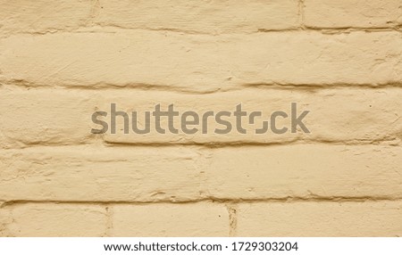 Fragment of a wall with painted bricks. Background and texture. Computer desktop wallpaper.
