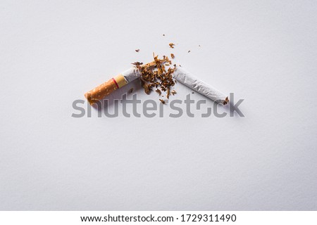World No Tobacco Day concept, May 31. Quitting smoking or No smoking sign made with broken cigarettes on white background.