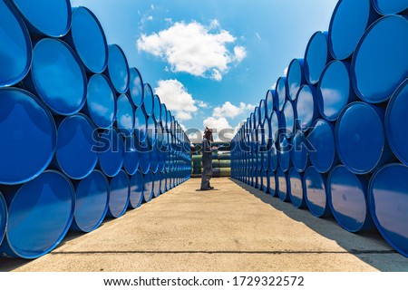 Male worker inspection record drum oil stock barrels blue horizontal or chemical for in industry Royalty-Free Stock Photo #1729322572