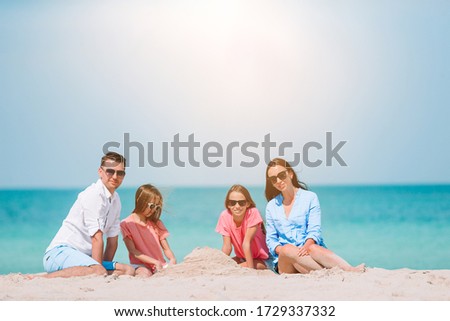Family of four on the beach vacation