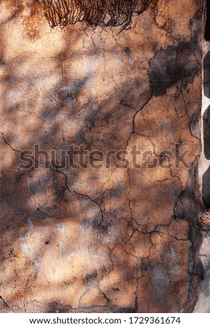Vertical photo of cracked yellow plaster. Unique shadow allover wall.