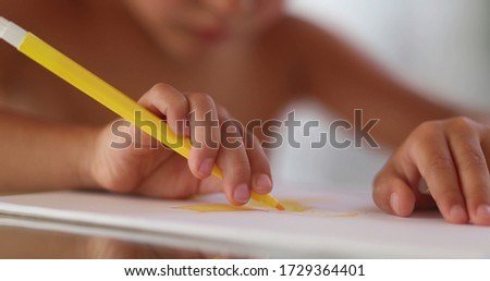 
Kid hands drawing and sketching on paper with color pen