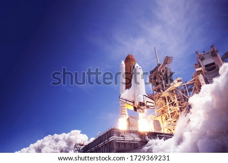 The launch of the space shuttle against the sky, fire and smoke. Elements of this image were furnished by NASA. Royalty-Free Stock Photo #1729369231
