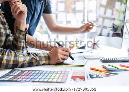 Team design of young Interior graphic designer working house project sketching on graphic tablet and color swatch working at modern office, creative inspiration and imagine.