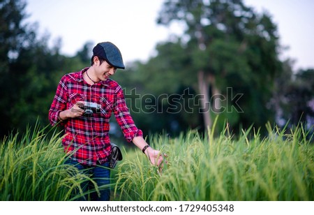 A man and a camera taking a photo and smiling happily Pictures for your business