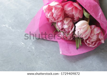 Beautiful bouquet of peonies on a gray background. Conceptual Women's Day, 8 March. March 8. Flat lay, top view, copy space.
