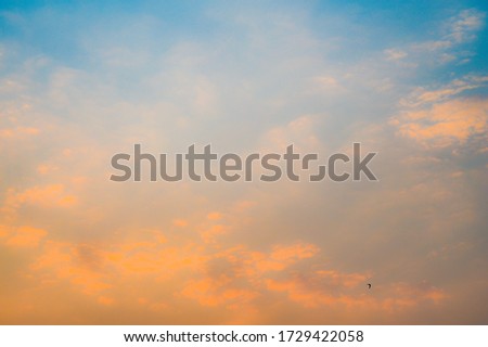 Beautiful sky with cloud before sunset. Colorful sky in twilight background. Bright Blue, Orange And Yellow Colors Sunset.