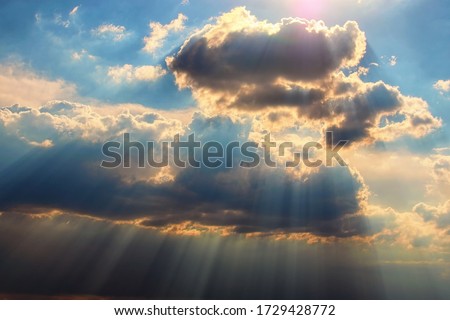 Astonishing blue sky with colorful white clouds. Abstract sun beam line light shining through the clouds. Sunbeam through the clouds on beautiful sky. Ukraine.  