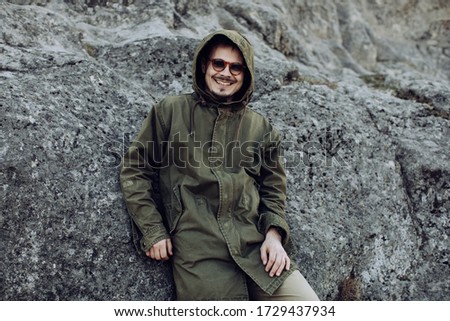 Young man smiling outdoors. Travel concept