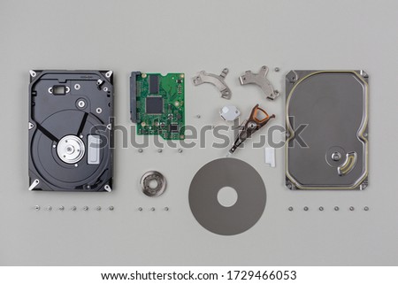 parts of a hard disk belonging to computer hardware, exploded one by one and arranged on a neutral background
 Royalty-Free Stock Photo #1729466053