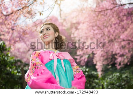 Hanbok: the traditional Korean dress and beautiful Asian girl with sakura