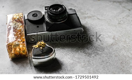 old photographic equipment on a stone floor flatlay