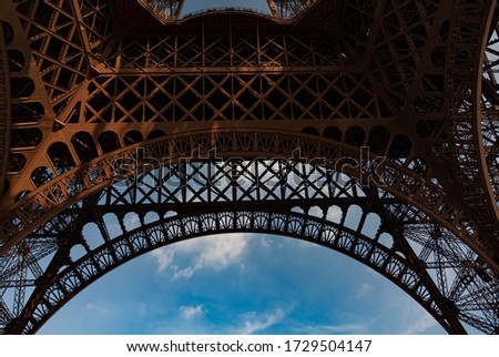 View from beneath Eiffel Tower with beautiful patterns and blue sky background