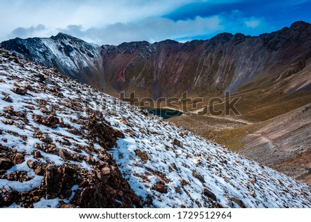 mountains, snow, mountain range wall that is actually a volcano crater, a lake within it. The power of nature.