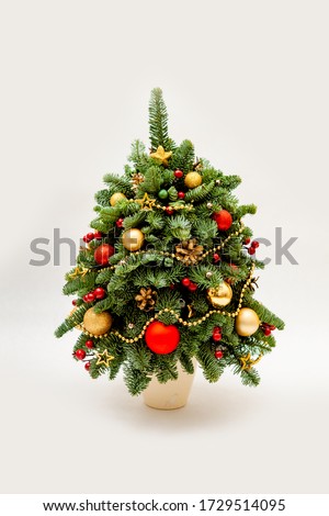 New Year tree made of fir decorated with flowers from cloth and balls