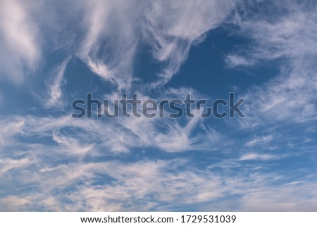 Blue sky background with big tiny stratus cirrus striped cloud