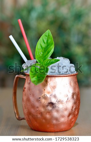 Pirate cocktail in metall cup on wooden background