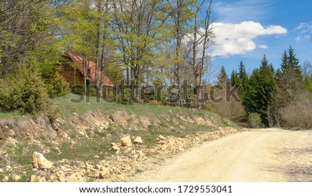 A cottage near the unpaved road.Village scenary image.