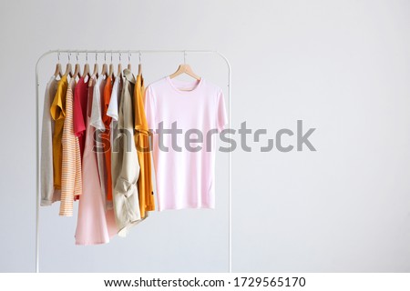 fashion clothes on a stand in a light background indoors. place for text
 Royalty-Free Stock Photo #1729565170