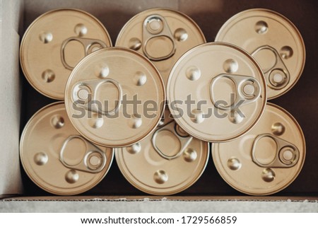 Metal closed canned food on a cardboard background. Top view. Copy, empty space for text Royalty-Free Stock Photo #1729566859
