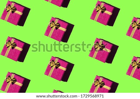 magenta gift boxes on a light green background. Seamless pattern, holiday concept. Festive background. Flat lay. Creative composition for Valentine's Day, love concept, birthday present, mother day, 