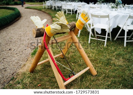 photo of a wedding a wooden sawhorse in the garden