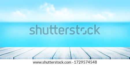 Summer tropical sea with empty wooden table and blue sunny sky. Wide template background with copy space for your product
