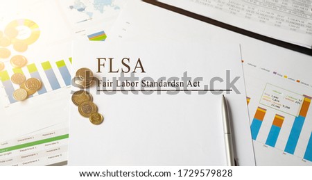 Paper with FLSA Fair Labor Standards Act on a table