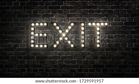 Bright sign on a dark brick wall that says EXIT made up of light bulbs, electric exit sign  