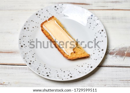 Bread with brie cheese on a plate on a wooden background.