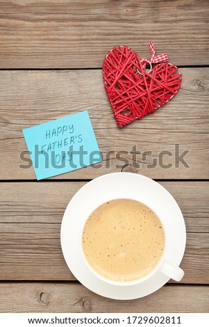 Happy Fathers Day greeting card and hearts on grey wooden background. Copy space